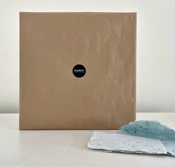 A brown box with Summer Garden, 30 x 30 x 2 inches, next to it.
